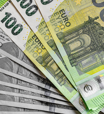 Euro and dollar bills in a common stack.