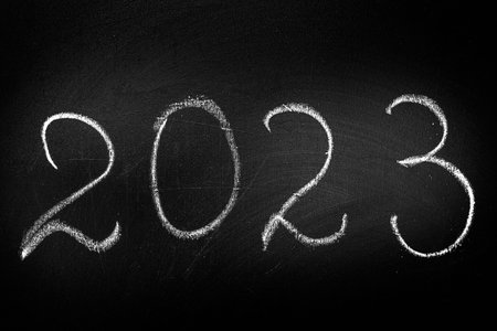 The inscription 2023 in chalk on a blackboard.の写真素材