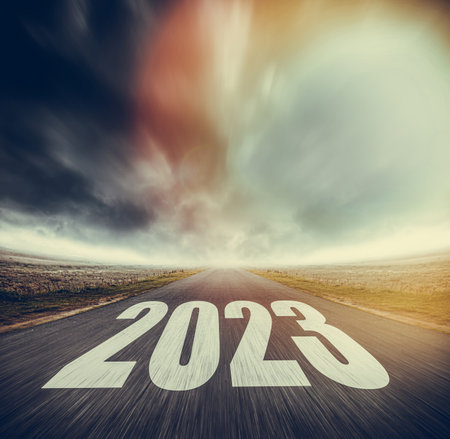 2023 written on highway road in the middle of asphalt road and dark cloudy sky.の写真素材