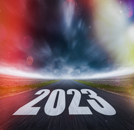 2023 written on highway road in the middle of asphalt road and dark cloudy sky.の写真素材