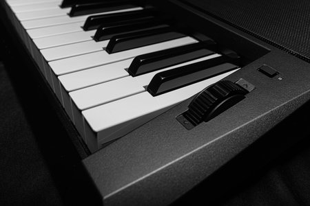 Keyboard synthesizer on a dark background.