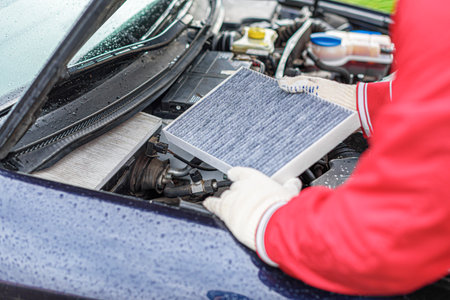 Change the filter on the car engine during vehicle maintenance.の写真素材