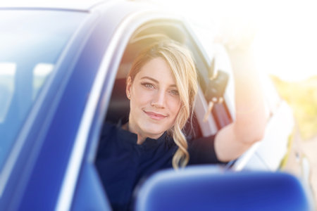 The woman driver shows the key to the car.