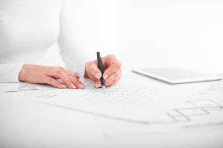 Engineers are conferring on project drawings.の写真素材