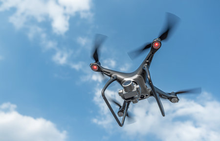 A black modern drone flies in the sky.の写真素材