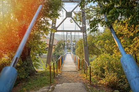 Suspension bridge in the park on an autumn day.