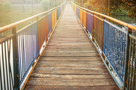 Suspension bridge in the park on an autumn day.
