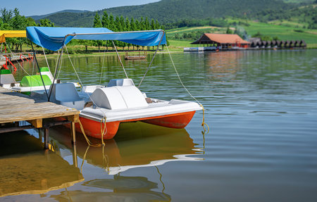 Catamarans on a pier on a lake.