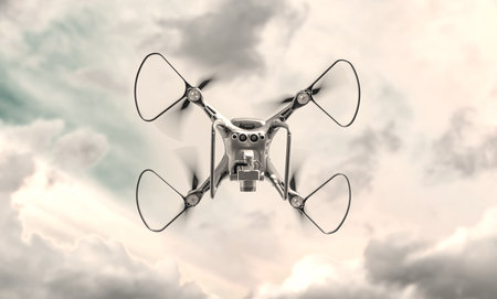 A black modern drone flies in the sky.