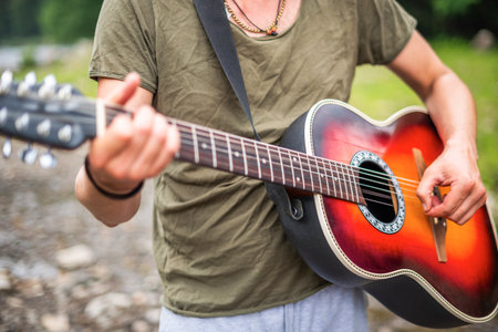A young man plays the guitar.の写真素材