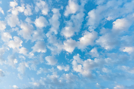 Bright blue sky filled with scattered white fluffy clouds