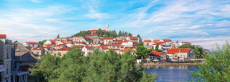 Charming coastal town of Primosten with red-roofed stone houses, a church towerの写真素材