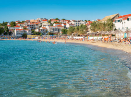 Sunny pebble beach with turquoise waves washing ashore