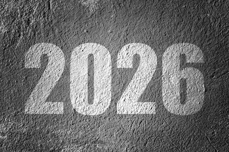 The number 2026 painted in white on a dark, textured surface, representing a new year concept.の写真素材