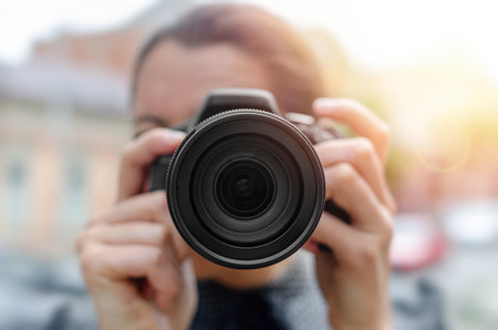 A photographer holding a DSLR cameraの写真素材