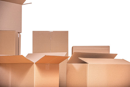 A collection of open and closed brown corrugated cardboard against a white background.