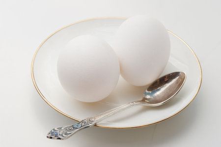 Two white eggs on a plate