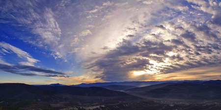 beautiful sunset behind the mountains の写真素材