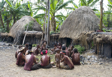NEW GUINEA, INDONESIA -DECEMBER 28: Unidentified women of a Papuan tribe in traditional clothes and coloring in New Guinea Island, Indonesia on December 28, 2010のeditorial素材