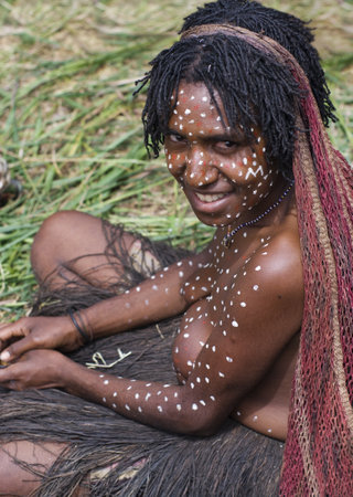 NEW GUINEA, INDONESIA -DECEMBER 28: The woman of a Papuan tribe in traditional clothes and coloring in New Guinea Island, Indonesia on December 28, 2010 のeditorial素材