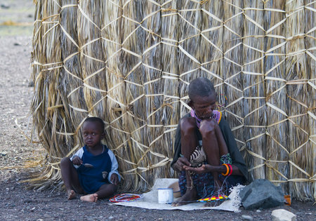 LAKE TURKANA, KENYA-JANUARY 12  El molo woman makes traditional necklace January 12, 2013 near lake...