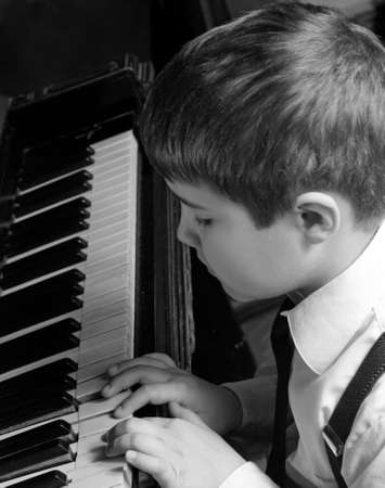 little boy playing the pianoの写真素材