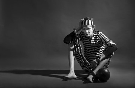 portrait of  mime prisoner over dark background 