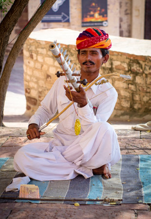 JODHPUR, INDIA - SERT 20: Indian musician in traditional dress playing musical instruments in Meherangarh fort, on sept 20, 2013 in Jodhpur, India のeditorial素材