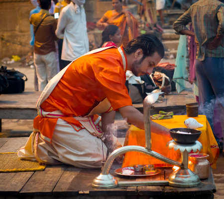 VARANASI, INDIA-01 OCT : A Hindu priest performs the religious ritual on 01 Oct, 2013 in Varanasi. Hindu ritual that takes place at Dashashwamedh Ghat on the banks of the river Ganges during sunrise. のeditorial素材