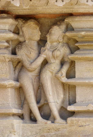 Stone carved erotic bas relief in Hindu temple in Khajuraho, India.の写真素材