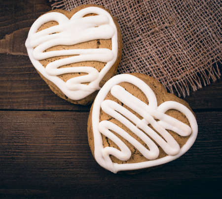 Homemade ginger cookies heart shaped   over wooden table  Valentineの写真素材