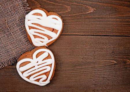 Homemade ginger cookies heart shaped   over wooden table  Valentineの写真素材