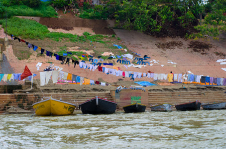 VARANASI, INDIA - OCTOBER 1: Washing clothes  in Ganges river, Varanasi, India  October 1, 2013 in Varanasi, India.のeditorial素材