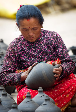 BHAKTAPUR, NEPAL - APR 5: Unidentified Nepalese woman working in the her pottery workshop, Apr 5, 2014 in Bhaktapur, Nepal.  のeditorial素材