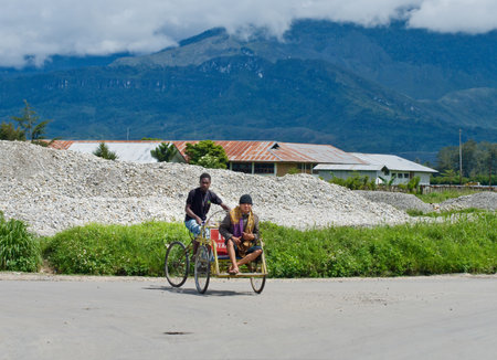 PAPUA PROVINCE, INDONESIA - DEC 27: A trishaw driver on the street   in Wamena, at island New Guinea, Indonesia on Dec 27, 2010.のeditorial素材