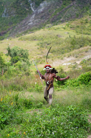 NEW GUINEA, INDONESIA -DECEMBER 28: Unidentified warriors of a Papuan tribe in traditional clothes are having a demonstration of war skills in New Guinea Island, Indonesia on December 28, 2010 のeditorial素材