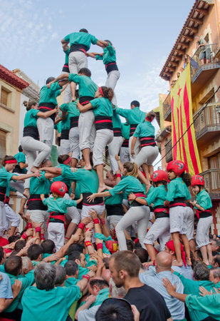 TORREDEMBARRA, SPAIN - JULY 13, 2014: Castells Performance   in Torredembarra, Catalonia, Spain. A Castell is a  Human Tower  built traditionally in Catalonia. のeditorial素材