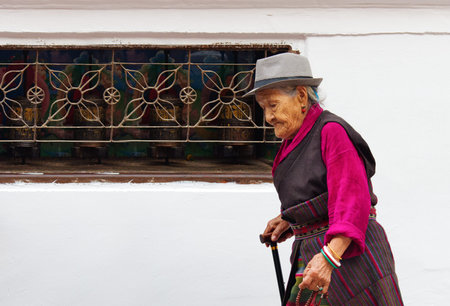 KATHMANDU, NEPAL - APR 06: Tibetan and Nepalese people  walking around  Boudhanath stupa  on Apr 06,...