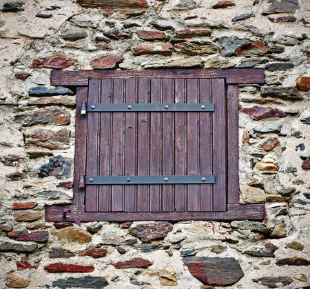 Window  in  the stone wall of an ancient building in France 
