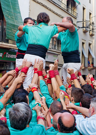 TORREDEMBARRA, SPAIN - JULY 13, 2014: Castells Performance   in Torredembarra, Catalonia, Spain. A Castell is a  Human Tower  built traditionally in Catalonia. のeditorial素材