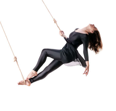 Young woman gymnast on the rope on white background の写真素材