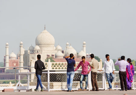 AGRA, INDIA -  SEPT 30, 2014: Tourists look at the Taj Mahal from Agra Fort in Agra, Uttar Pradesh, Indiaのeditorial素材