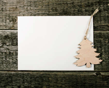 Card with Christmas tree on wooden backgroundの写真素材