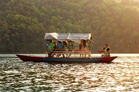 POKHARA, NEPAL - MARCH 30: Unidentified tourists do boating on Fewa lake on March 30, 2014 in Pokhara, Nepal. Pokhara is a popular tourist destination in Nepal.のeditorial素材