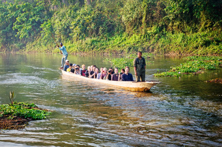 CHITWAN, NEPAL - APR 2:Tourists in canoe on the river in Chitwan national park on Apr 2, 2014, Nepalのeditorial素材