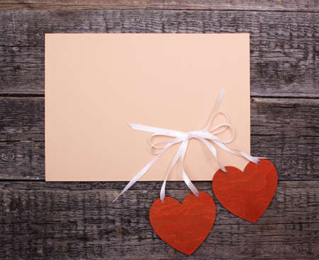 postcard with hearts on a wooden backgroundの写真素材