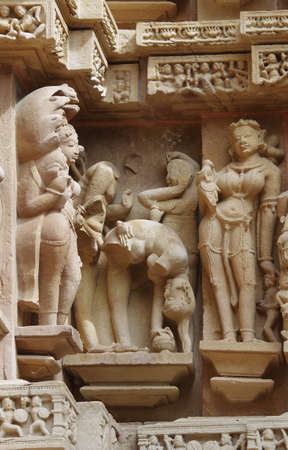 Stone carved erotic bas relief in Hindu temple in Khajuraho, India. Unesco World Heritage Siteの写真素材