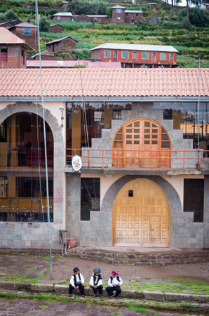 TAQUILE, PERU - MARCH 20, 2015:Men in  traditional clothes at Taquile Island at lake Titicaca in Peruのeditorial素材