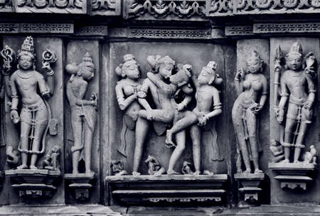 Stone carved erotic bas relief in Hindu temple in Khajuraho, India. の写真素材