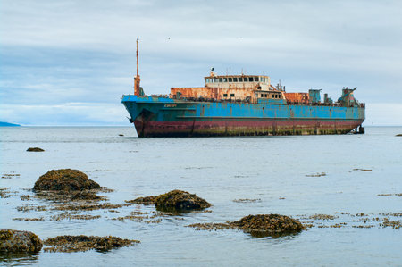 PARAMUSHIR, RUSSIA - JULY 28, 2012: Abandoned transport refrigerator "Sungach" run aground during a storm near the island Paramushir 8 March 2009.のeditorial素材